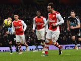 Arsenal's Spanish midfielder Santi Cazorla chips the ball as he scores their fourth goal from the penalty spot during the English Premier League football match between Arsenal and Newcastle United at the Emirates Stadium in London on December 13, 2014
