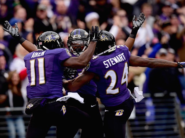 Wide receiver Kamar Aiken #11 of the Baltimore Ravens celebrates with free safety Darian Stewart #24 and linebacker Zach Orr #54 after scoring a first quarter touchdown off a blocked punt against the Jacksonville Jaguars at M&T Bank Stadium on December 14