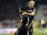 Bayern Munich's Moroccan Mehdin Benatia and Bayern Munich's Dutch midfielder Arjen Robben celebrate after the first goal during the German First division Bundesliga football match FC Augsburg vs FC Bayern Muenchen in Augsburg, southern Germany, on Decembe