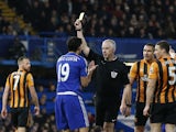 Referee Chris Foy shows Chelsea's Brazilian-born Spanish striker Diego Costa a yellow card for simulation during the English Premier League football match between Chelsea and Hull City at Stamford Bridge in London on December 13, 2014