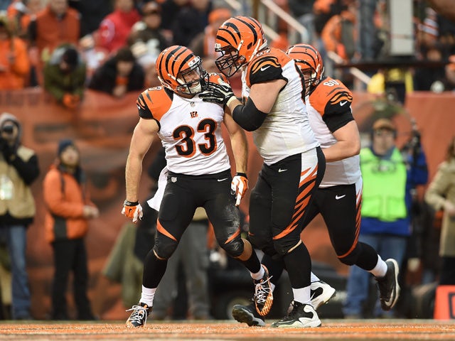 Rex Burkhead #33 of the Cincinnati Bengals celebrates his touchdown with Mike Pollak #67 during the fourth quarter against the Cleveland Browns at FirstEnergy Stadium on December 14, 2014