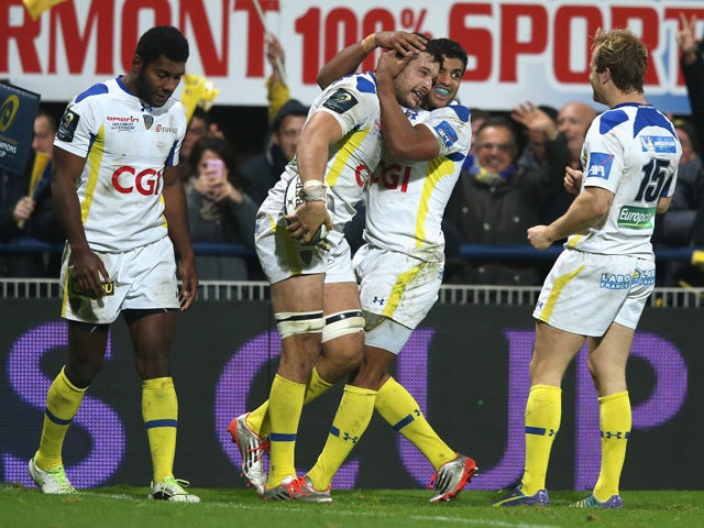 Damien Chouly of Clermont Auvergne is congratulated by teams mates after scoring his second try during the European Rugby Champions Cup pool one match between ASM Clermont Auvergne and Munster at Stade Marcel Michelin on December 14, 2014