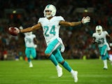Cortland Finnegan #24 of the Miami Dolphins celebrates after returning a fumble 50 yards to score a touchdown during the NFL match against the Oakland Raiders on September 28, 2014