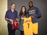 Prince William, Duke of Cambridge and Catherine, Duchess of Cambridge pose with basketball player LeBron James (R) backstage as they attend the Cleveland Cavaliers vs. Brooklyn Nets game at Barclays Center on December 8, 2014