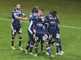 Evian's teammates celebrate after Evian's French midfielder Cedric Cambon celebrates after scoring a goal during the French L1 Football match Reims vs Evian, on December 13, 2014