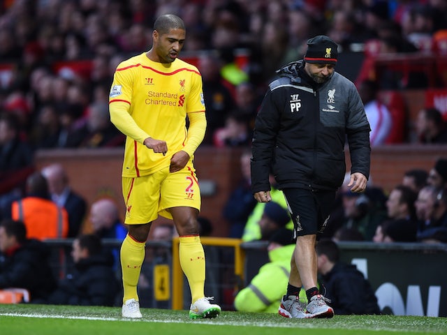 Glen Johnson of Liverpool goes off after sustaining an injury during the Barclays Premier League match against Manchester United on December 14, 2014