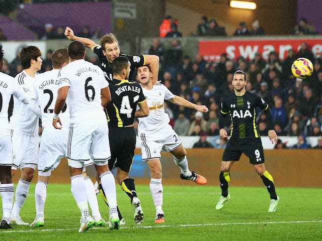 Harry Kane of Tottenham Hotspur heads the opening goal during the Barclays Premier League match against Swansea City on December 14, 2014