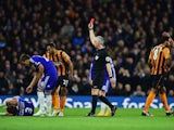 Referee Chris Foy shows a red card to Tom Huddlestone of Hull City after a challenge on Filipe Luis of Chelsea during the Barclays Premier League match between Chelsea and Hull City at Stamford Bridge on December 13, 2014