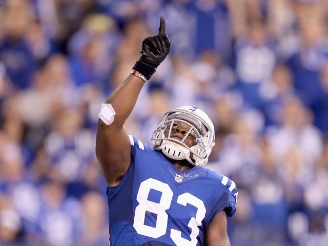 Dwayne Allen #83 of the Indianapolis Colts celebrates after scoring a touchdown during the game against the Houston Texans at Lucas Oil Stadium on December 14, 2014