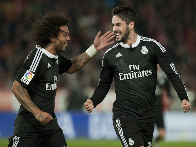 Real Madrid's forward Isco (R) celebrates with Brazilian defender Marcelo after scoring during the Spanish league football match UD Almeria vs Real Madrid CF on December 12, 2014