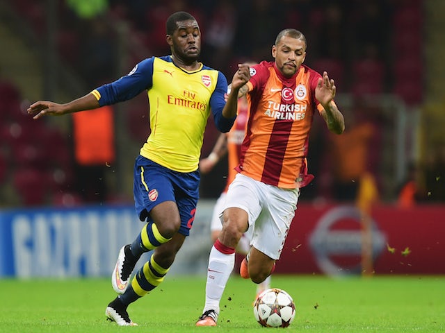 Joel Campbell of Arsenal battles with Felipe Melo of Galatasaray during the UEFA Champions League Group D match on December 9, 2014