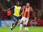 Joel Campbell of Arsenal battles with Felipe Melo of Galatasaray during the UEFA Champions League Group D match on December 9, 2014