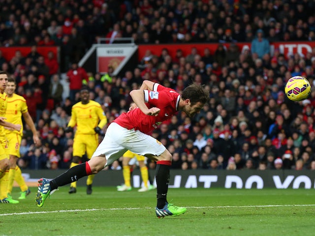 Manchester United's Juan Mata scores against Liverpool on December 14, 2014