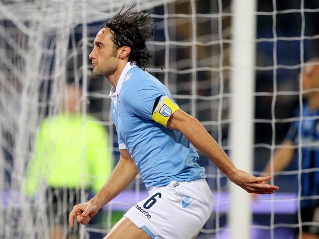 Stefano Mauri of SS Lazio celebrates after scoring the opening goal during the Serie A match between SS Lazio and Atalanta BC at Stadio Olimpico on December 13, 2014