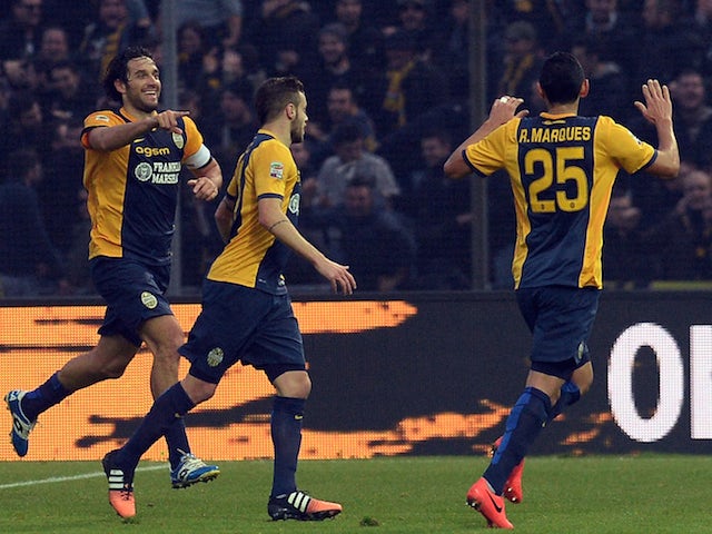 Luca Toni (L) of Hellas Verona celebrates after scoring his team's first goal during the Serie A match against Udinese Calcio on December 14, 2014