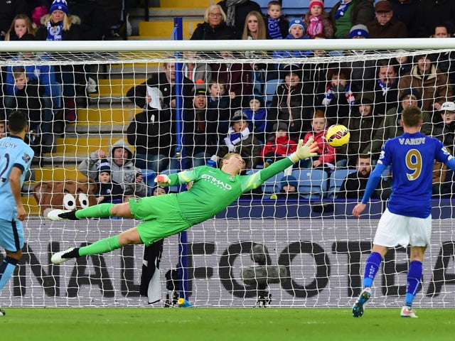 Manchester City's English goalkeeper Joe Hart dives to cover a direct free kick from Leicester City's Argentinian midfielder Esteban Cambiasso that goes wide during the English Premier League football match between Leicester City and Manchester City at Ki