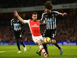 Mathieu Debuchy of Arsenal tackles Fabricio Coloccini of Newcastle United during the Barclays Premier League match on December 13, 2014