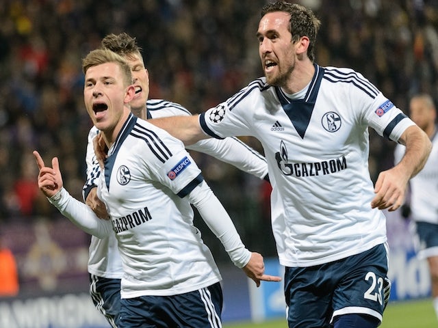 Schalke's midfielder Max Meyer (L) celebrates with defender Christian Fuchs (R) after scoring a goal during the UEFA Champions League Group G football match against NK Maribor on December 10, 2014