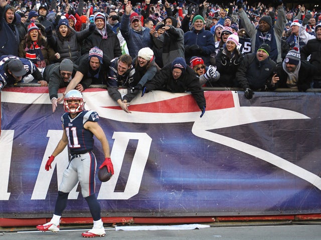 Julian Edelman #11 of the New England Patriots reacts after catching a touchdown pass during the third quarter against the Miami Dolphins at Gillette Stadium on December 14, 2014