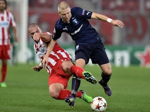 Olympiakos' Pajtim Kasami (L) fights for the ball with Malmo's defender Anton Tinnerholm (R) during the UEFA Champions League Group A football match on December 9, 2014