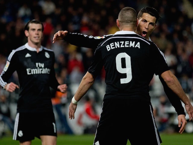 Gareth Bale, Karim Benzema and Cristiano Ronaldo celebrate Real Madrid's third goal during the La Liga match against Almeria on December 12, 2014