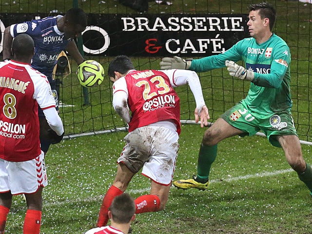 Reims' Franco-Algerian defender Aissa Mandi scores a goal during a French L1 Football match Reims vs Evian, at the Auguste Delaune Stadium in Reims on December 13, 2014