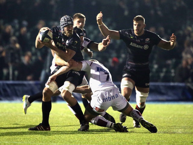 Alistair Hargreaves of Saracens takes on the Sale Sharks defence during the European Rugby Champions Cup match between Saracens and Sale Sharks at Allianz Park on December 13, 2014