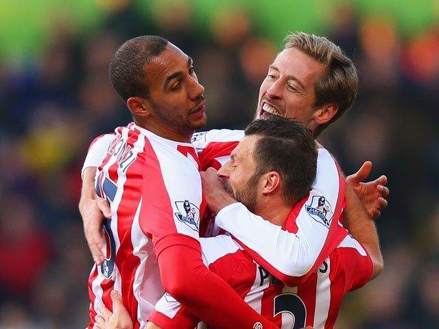 Peter Crouch of Stoke City celebrates with team mates Steven N'Zonzi and Erik Pieters as he scores their first goal during the Barclays Premier League match between Crystal Palace and Stoke City at Selhurst Park on December 13, 2014
