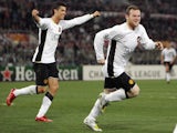Manchester United's English forward Wayne Rooney (R) celebrates with his teammate Portugese midfielder Cristiano Ronaldo after scoring against AS Roma during their Champions League quarter-final on April 1, 2008