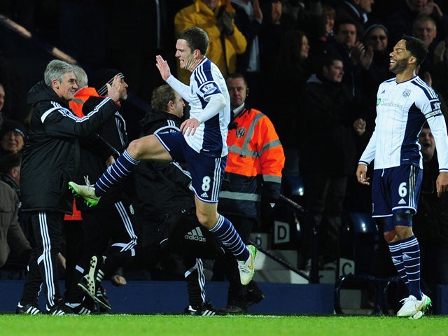 WBA player Craig Gardner celebrates his goal with manager Alan Irvine during the Barclays Premier League match between West Bromwich Albion and Aston Villa at The Hawthorns on December 13, 2014