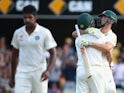 Mitch Marsh of Australia and Mitchell Johnson of Australia embrace as Marsh hits the winning runs to win the test during day four of the 2nd Test match between Australia and India at The Gabba on December 20, 2014