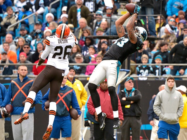 Kelvin Benjamin #13 of the Carolina Panthers makes a leaping catch against Pierre Desir #26 of the Cleveland Browns in the 1st half during their game at Bank of America Stadium on December 21, 2014