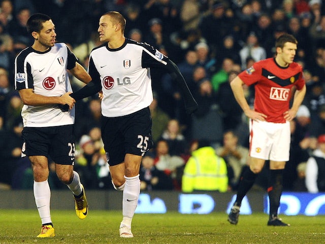 Fulham's USA player Clint Dempsey (L) congratulates Fulham's English striker Bobby Zamora (R) after he scores the second goal during the English Premier League football match on December 19, 2009