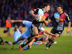 George Lowe of Harlequins is tackled by Juan Pablo Socino of Newcastle Falcons during the Aviva Premiership match between Harlequins and Newcastle Falcons at the Twickenham Stoop on December 20, 2014 in