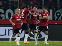 Hannover's Spanish striker Joselu (3rd L) celebrates after scoring his team's second goal with Maurice Hirsch and Salif Sane on December 16, 2014