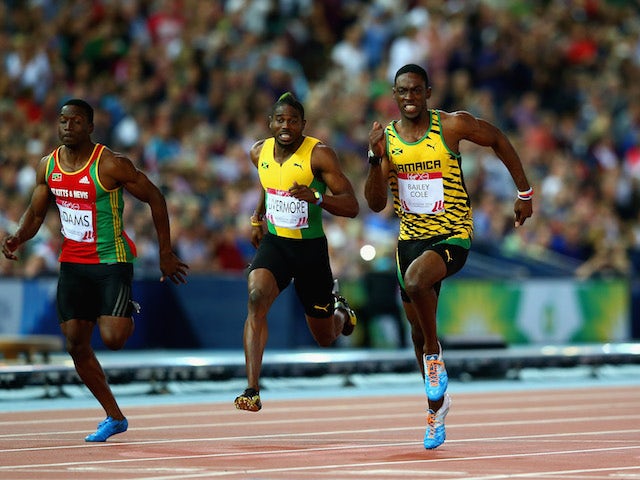 Kemar Bailey-Cole of Jamaica (2R) crosses the line to win gold ahead of silver medalist Adam Gemili of England (R) in the Mens 100 metres Commonwealth Games final on July 29, 2014