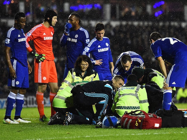 John Terry of Chelsea talks to medical staff as they treat Kurt Zouma of Chelsea during the Capital One Cup Quarter-Final match against Derby on December 16, 2014
