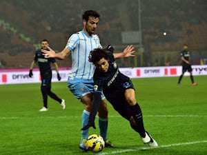 Lazio's midfielder Marco Parolo fights for the ball with Inter Milan's defender from Brazil Dodo during their Serie A football match Inter Milan vs Lazio at San Siro Stadium in Milan on December 21, 2014
