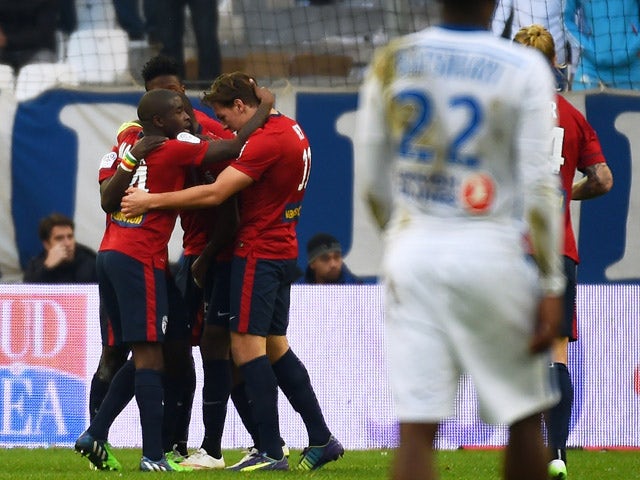 Lille's players celebrate after their Senegalese midfielder Idrissa Gueye scored a goal during the French L1 football match Marseille (OM) vs Lille (LOSC) on December 21, 2014