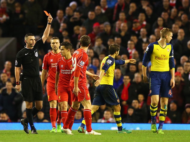 Fabio Borini of Liverpool is shown the red card by referee Michael Oliver during the Barclays Premier League match between Liverpool and Arsenal at Anfield on December 21, 2014