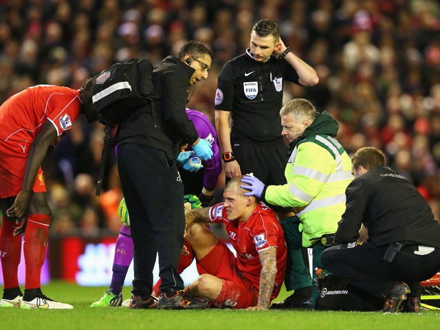 Martin Skrtel of Liverpool receives treatment for a head wound during the Barclays Premier League match between Liverpool and Arsenal at Anfield on December 21, 2014