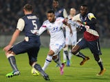 Bordeaux's Senegalese defender Ludovic Sane vies with Lyon's French forward Alexandre Lacazette during the French L1 football match between Girondins de Bordeaux (FCGB) and Lyon (OL) on December 21, 2014