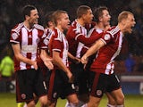 Marc McNulty of Sheffield United (protective mask) celebrates scoring the opening goal with team mates during the Capital One Cup Quarter-Final match against Southampton on December 16, 2014