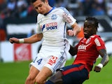 Marseille's French midfielder Florian Thauvin vies for the ball with Lille's Senegalese defender Pape Souare during the French L1 football match Marseille (OM) vs Lille (LOSC) on December 21, 2014