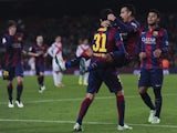 Barcelona's forward Pedro Rodriguez (up) is congratulated by his teammate Barcelona's forward Munir el Haddadi after scoring during the Spanish Copa del Rey match agains Huesca on December 16, 2014