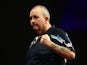 Phil Taylor of England celebrates winning his first round match against Jyhan Artut of Germany on Day Two of the William Hill PDC World Darts Championships at Alexandra Palace on December 19, 2014