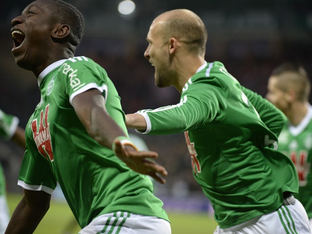 Saint-Etienne's Ivorian forward Max-Alain Gradel celebrates with his teammates after opening the scoring during the French L1 football match AS Saint-Etienne (ASSE) vs Evian (ETGFC) on December 21, 2014
