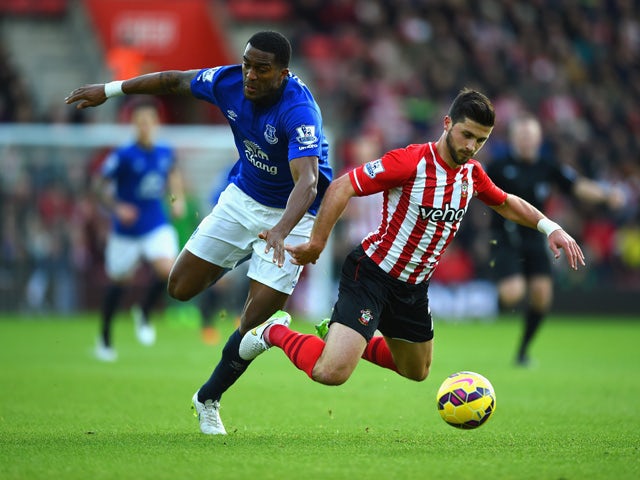 Sylvain Distin of Everton and Shane Long of Southampton battle for the ball during the Barclays Premier League match between Southampton and Everton at St Mary's Stadium on December 20, 2014