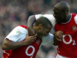 Arsenal's Thierry Henry is congratulated by teammate Sol Campbell after scoring against Tottenham during a premier league match at Highbury Stadium in north London, 16 November 2002