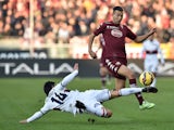 Omar El Kaddouri of Torino FC is tackled by Facundo Roncaglia of Genoa CFC during the Serie A match betweeen Torino FC and Genoa CFC at Stadio Olimpico di Torino on December 21, 2014